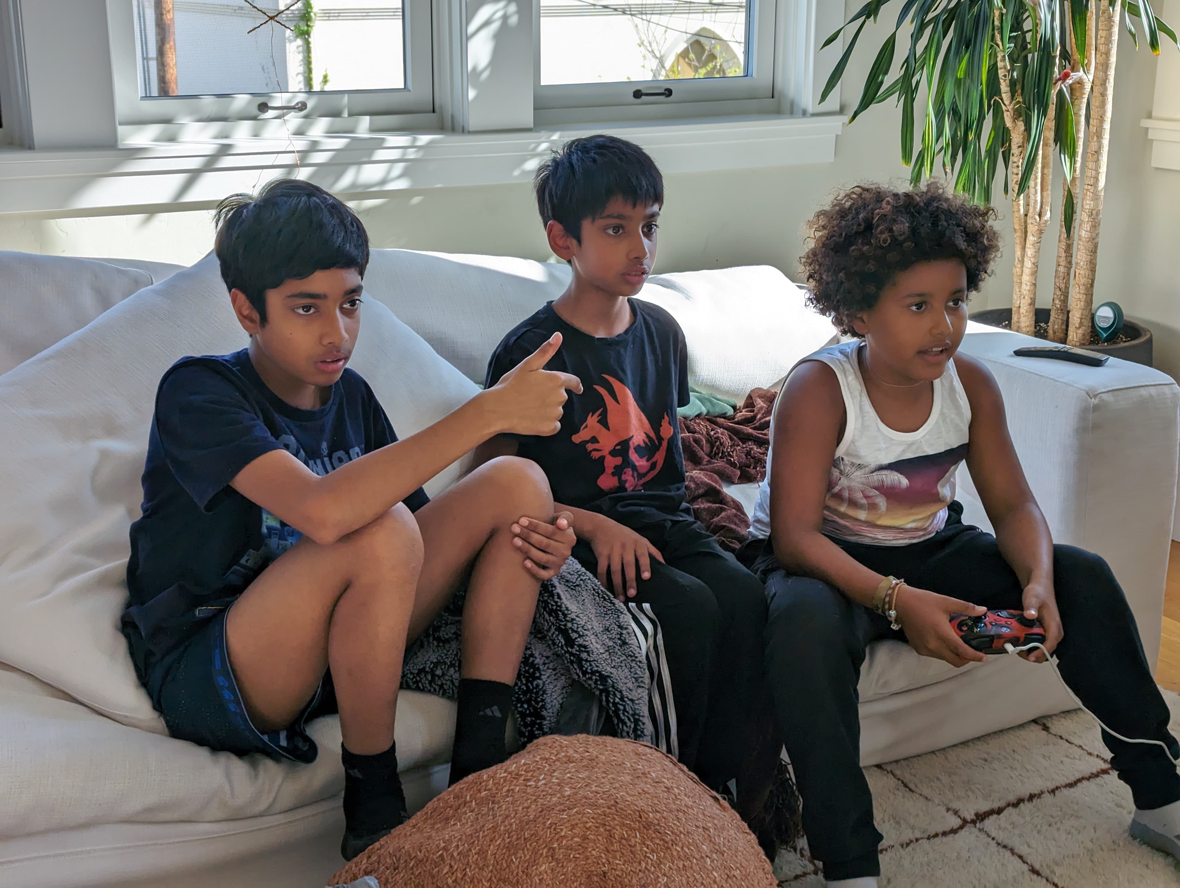 Our three kids playing a video game together